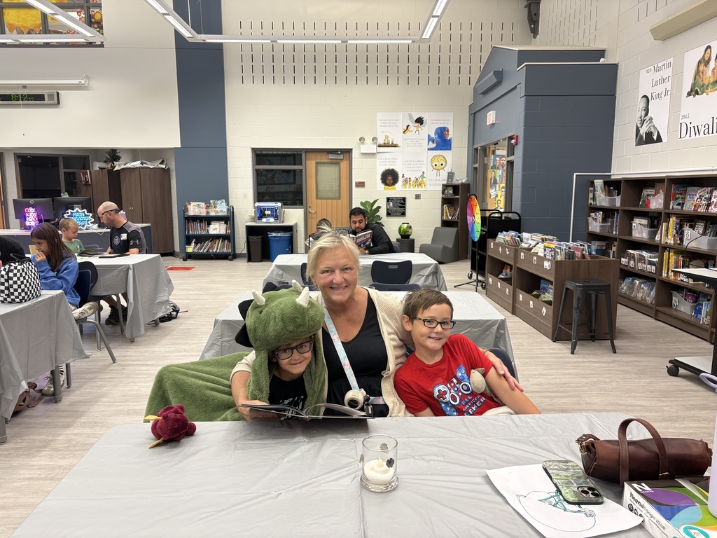 Parents and children reading in a library. 