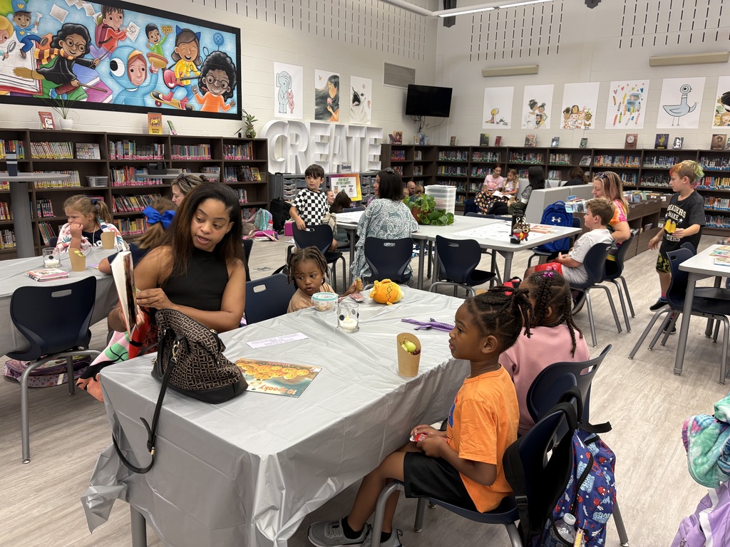 Parents and children reading in a library. 