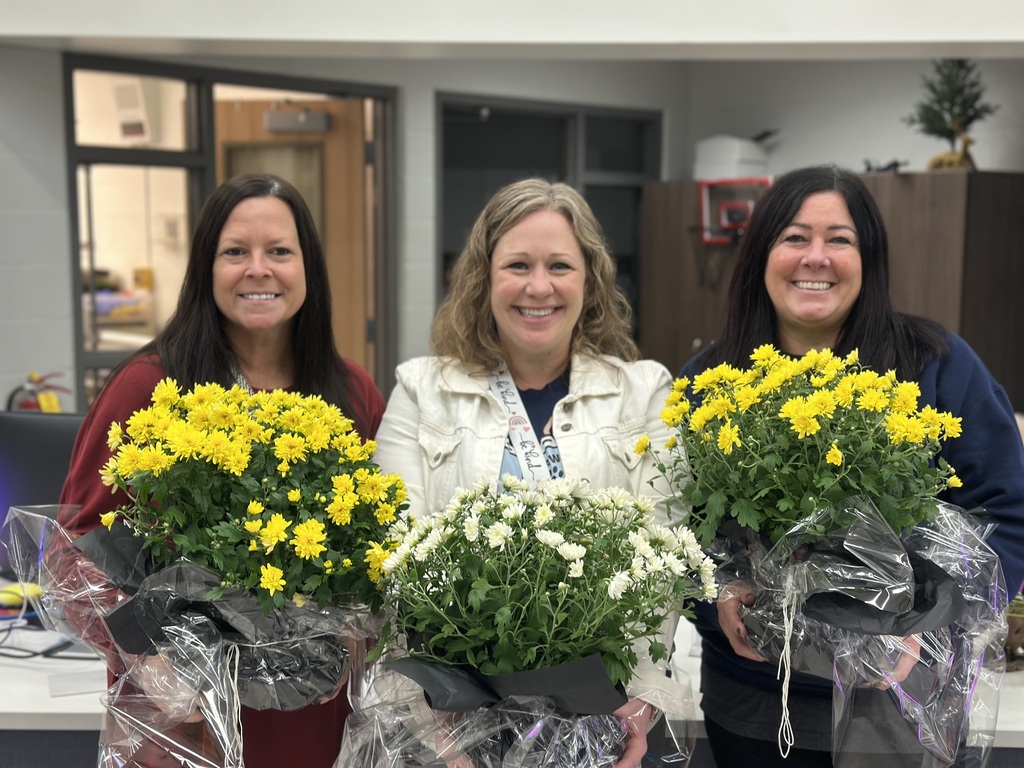 Three women holding mums.