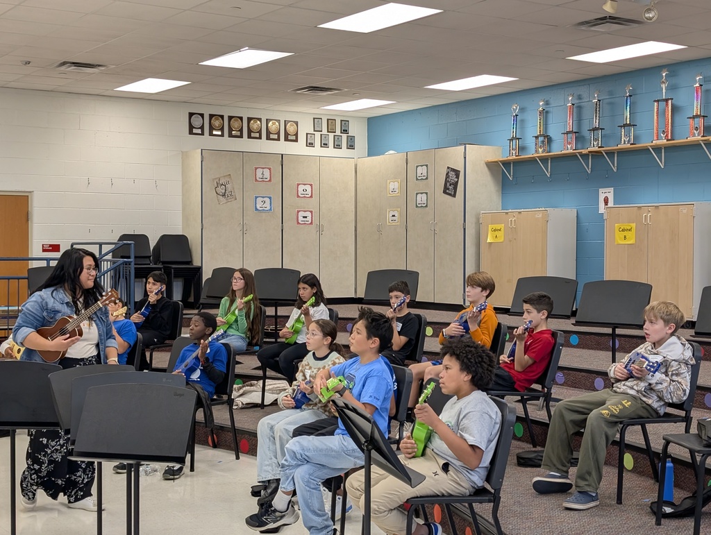 Students are playing instruments in a music room.