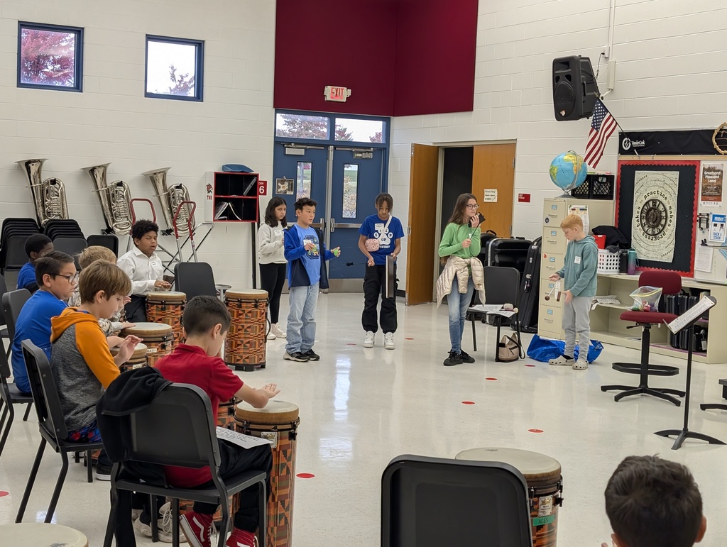 Students in a music room practicing rhythm.