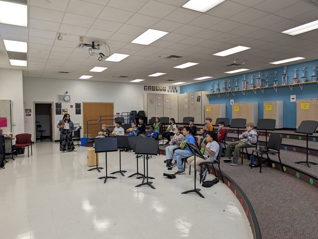 Students are playing instruments in a music room.