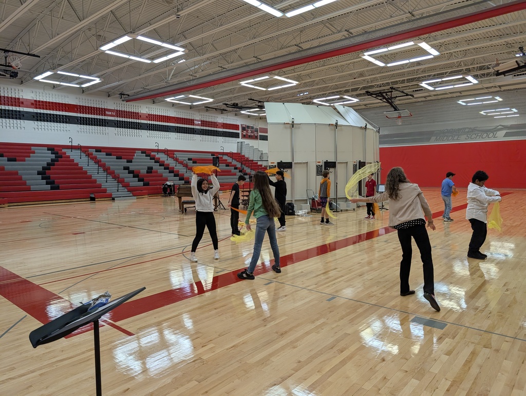 Students are in a gym practicing rhythm.