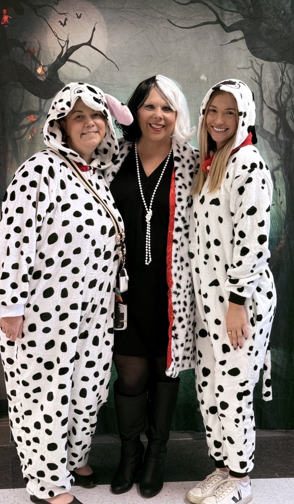 Three teachers dressed as 101 Dalmatians.