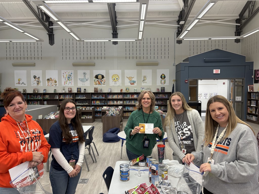 Teachers putting food in bags.