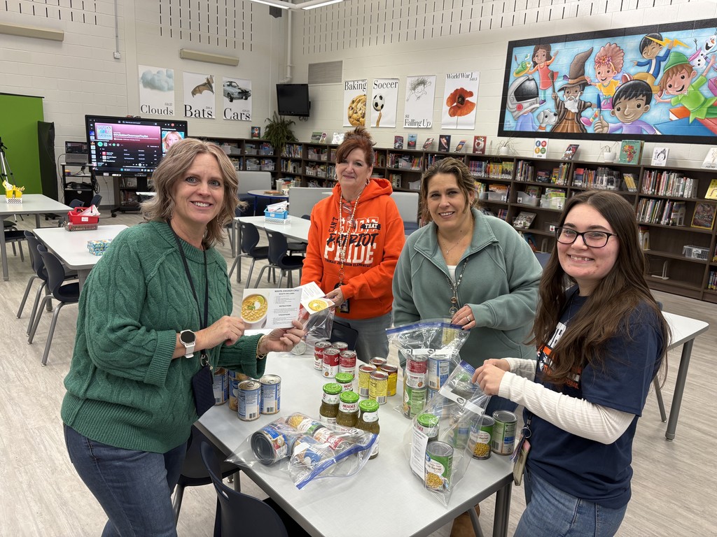 Teachers putting food in bags.
