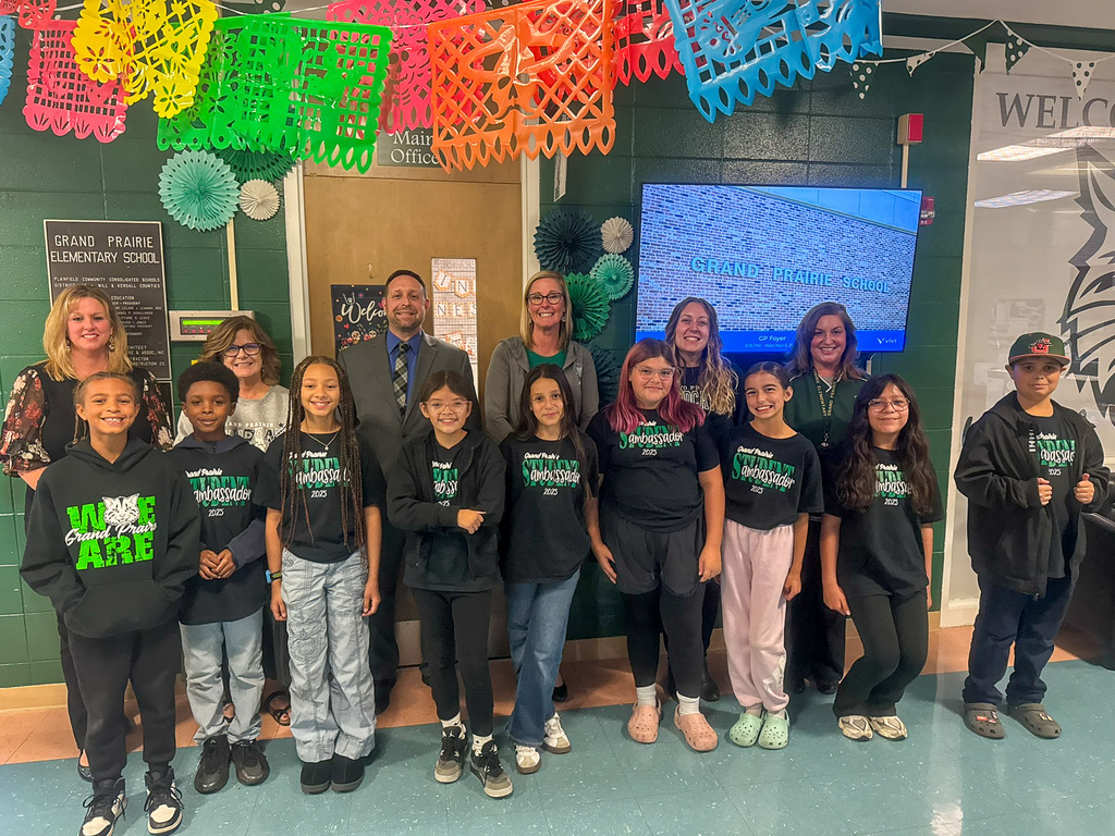 group of students and adults stand in hallway