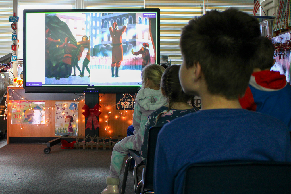 students watch Polar Express book on big screen
