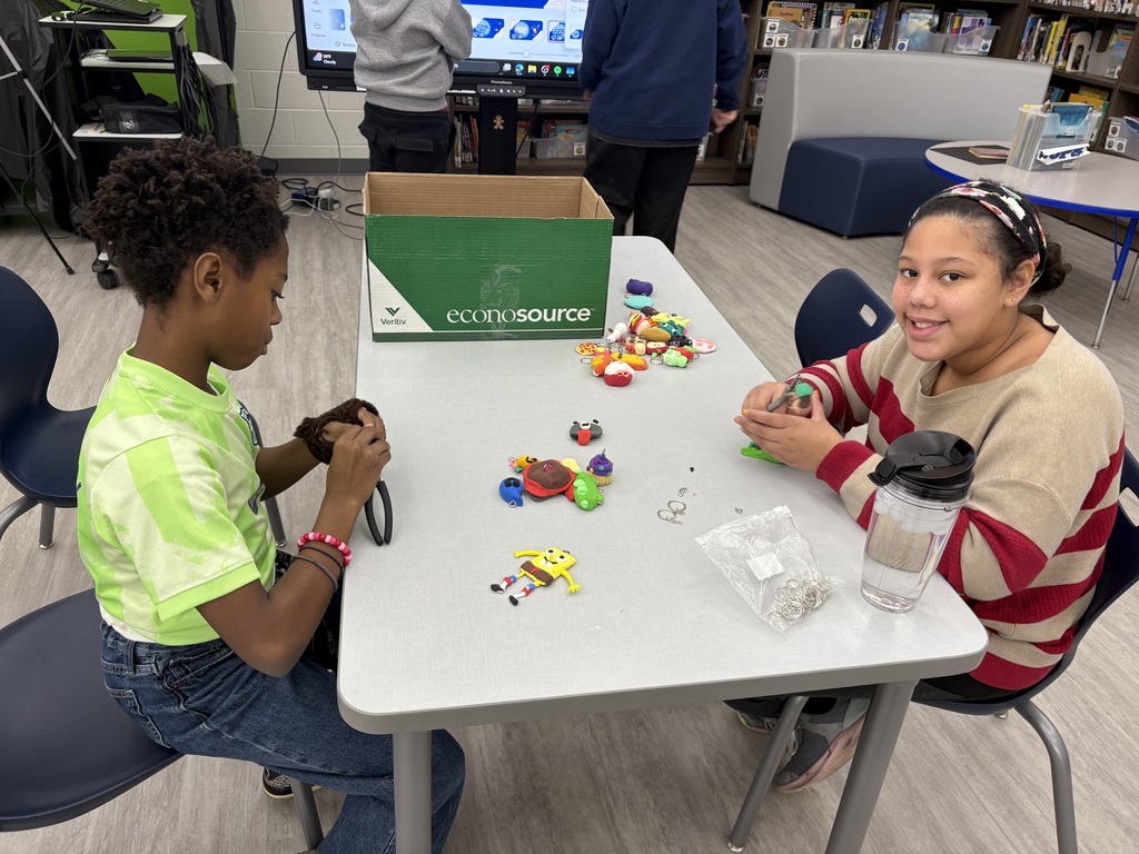 Students making keychains in a library.