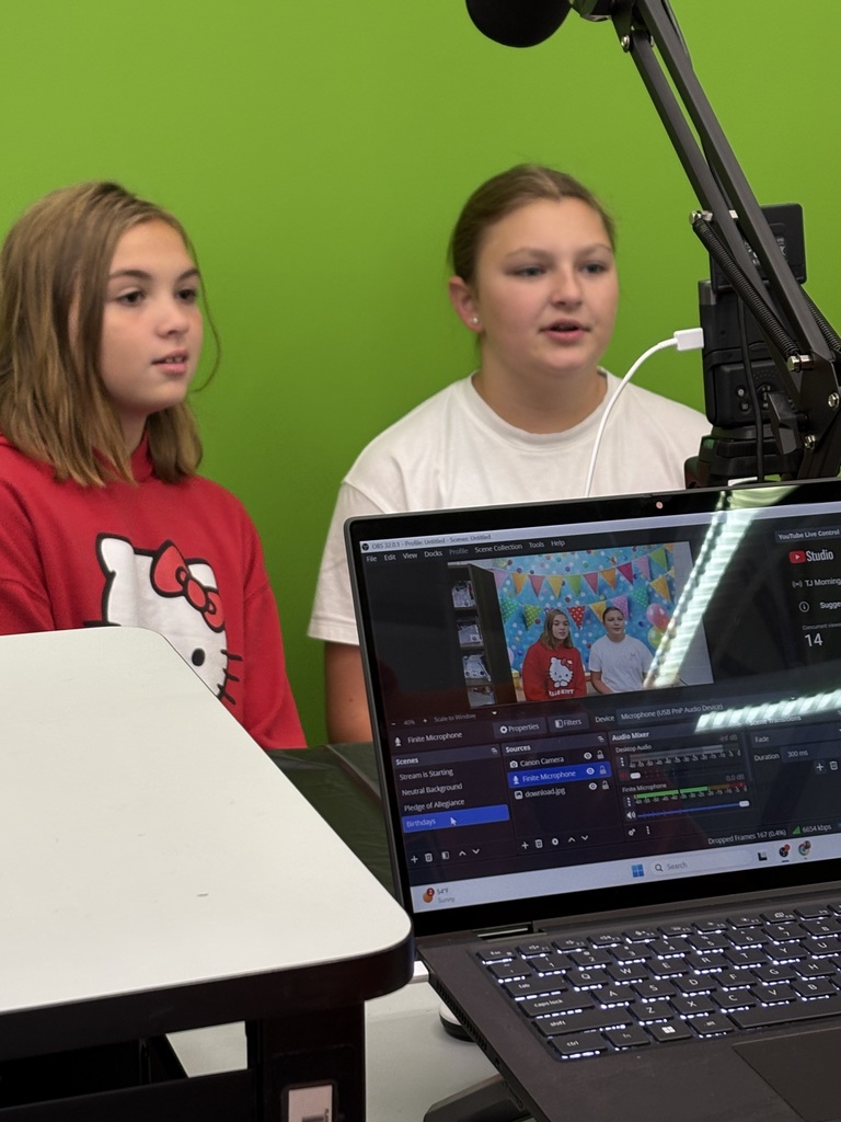 Two students recording morning announcements