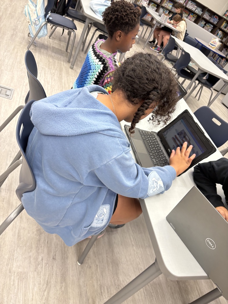 Students working on computers in a library