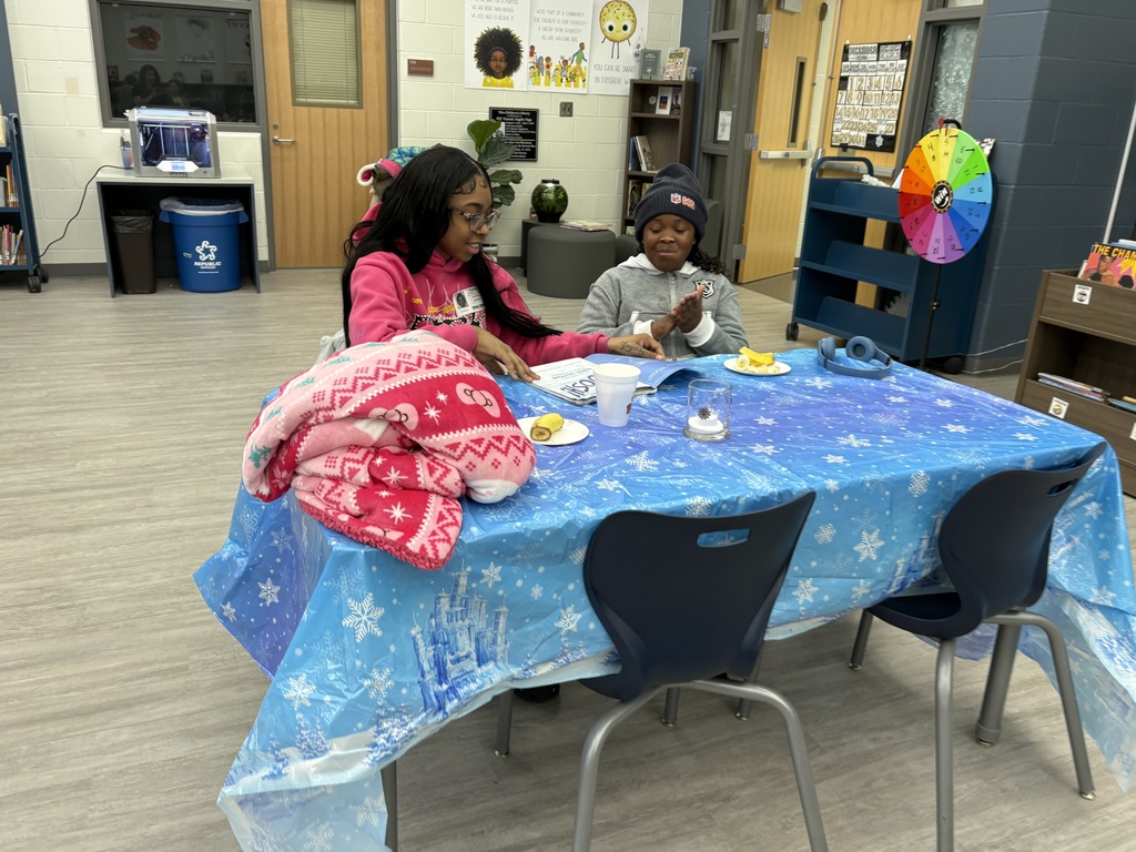 A family reading in the media center. 