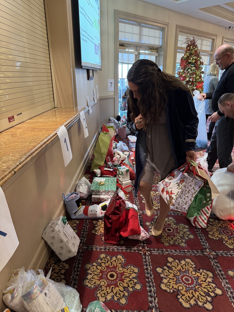 woman holds Christmas gifts while looking for others