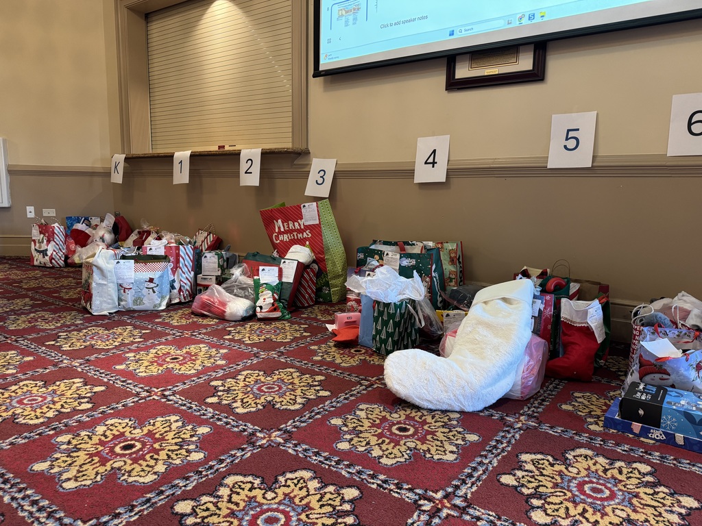 gifts and Christmas stockings line a wall