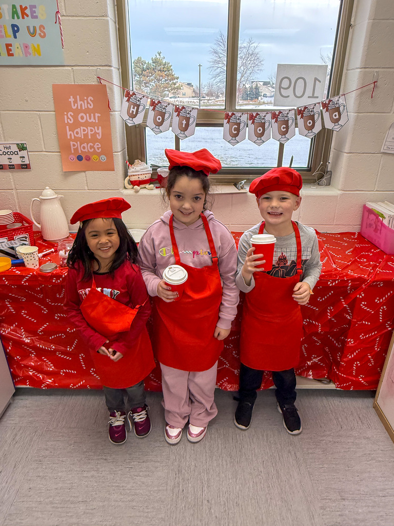 three kindergarten students dressed chefs holding coffee cups
