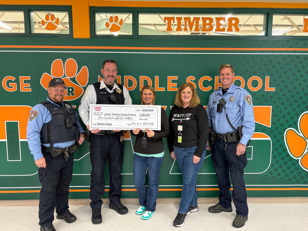 Five people stand two in middle hold oversized check for $385