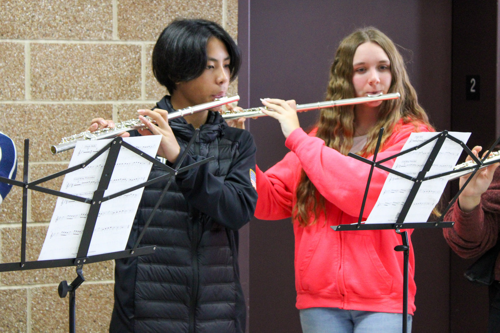 two middle school students play flutes