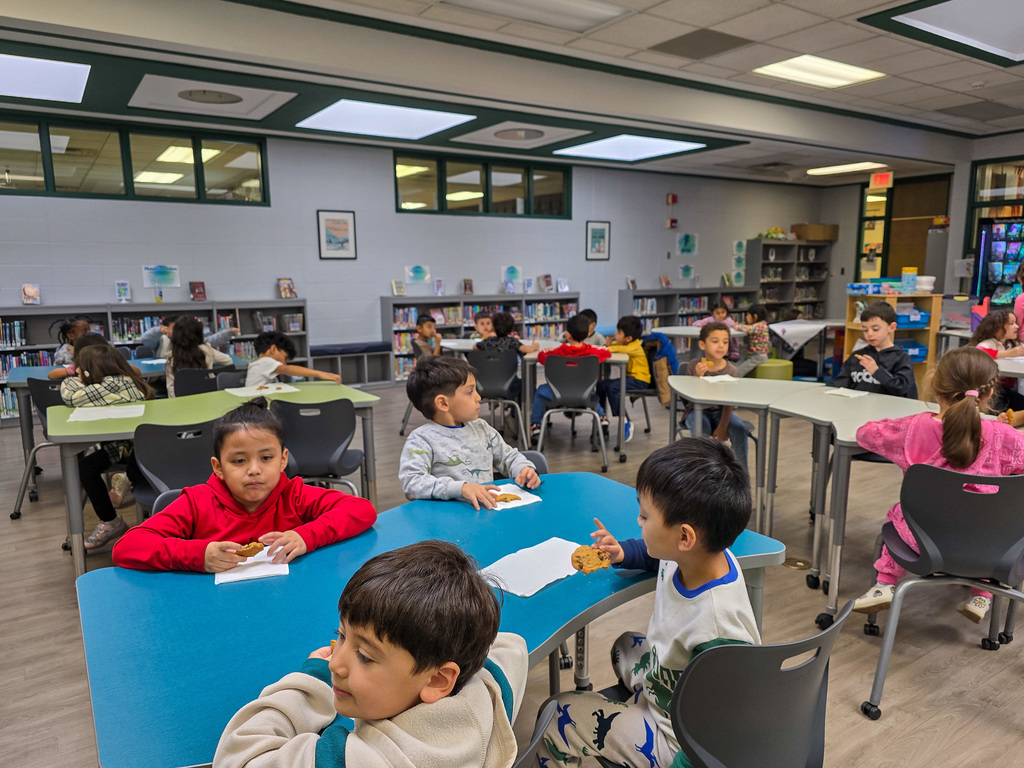 group of students in media center eating cookies