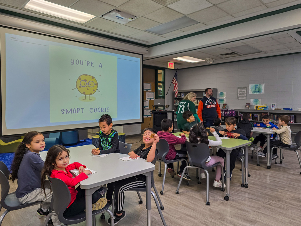 Group of students eating cookies in media center