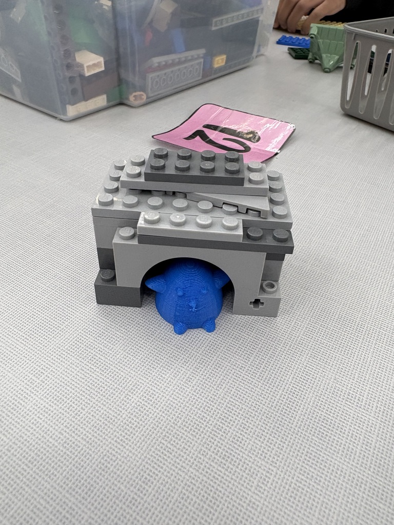 A small lego house with a 3D printed penguin. 