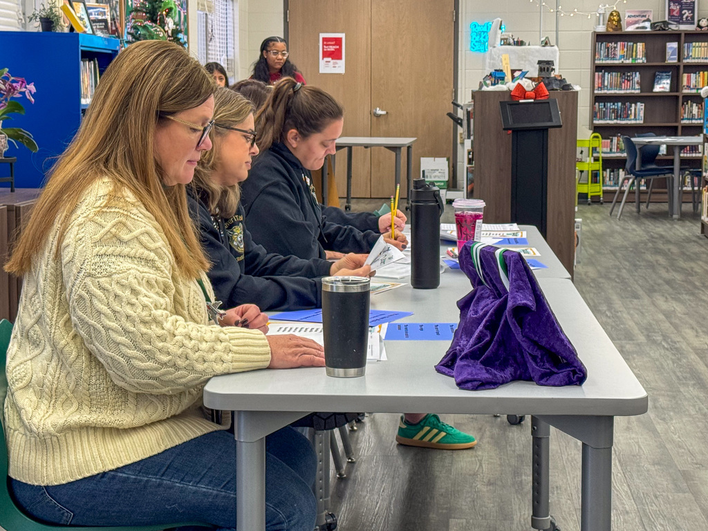 spelling bee judges sit at table