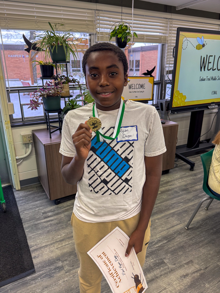 one student hold medal after winning spelling bee