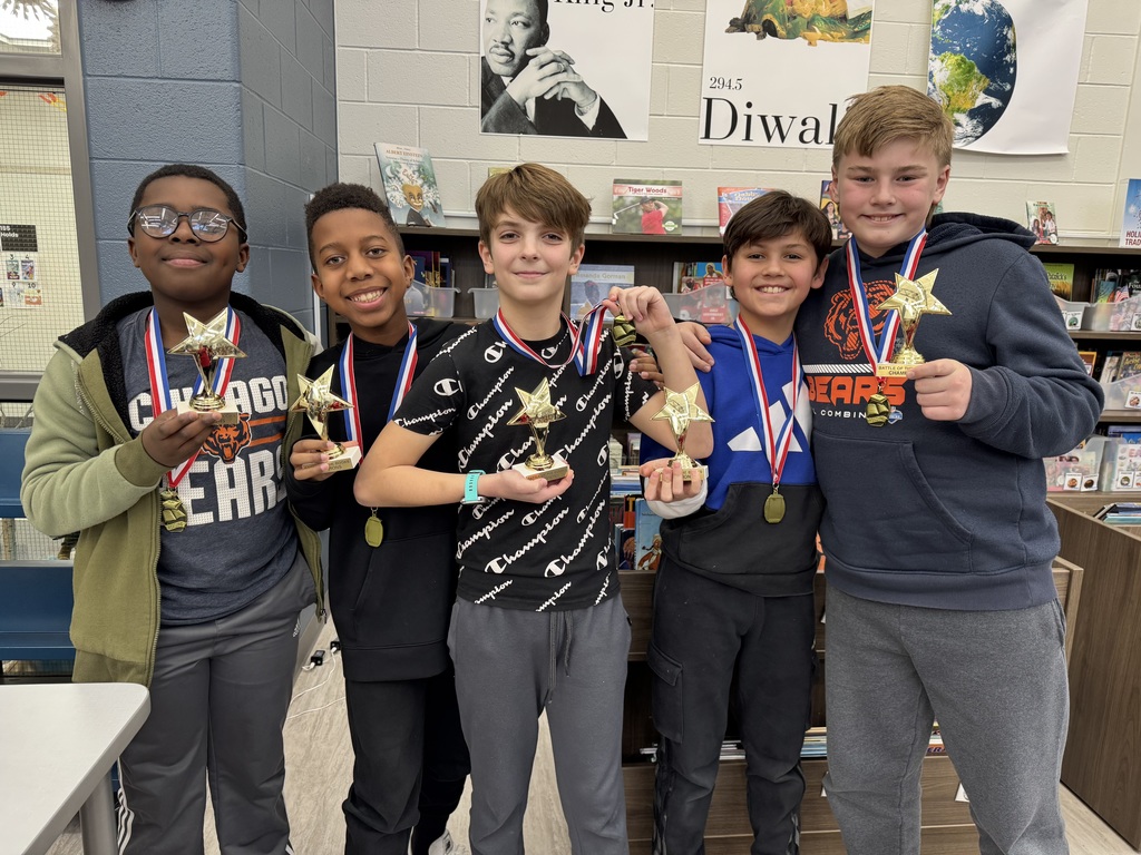 Students in a library watching a reading competition.