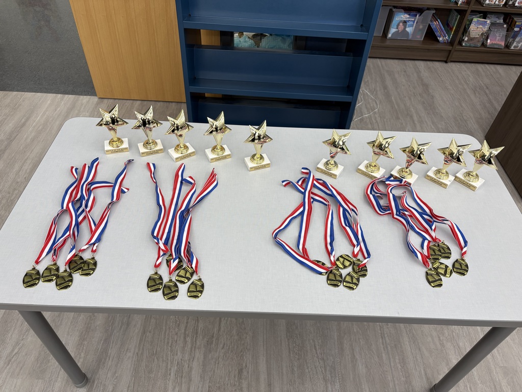 Trophies and medals on a table. 
