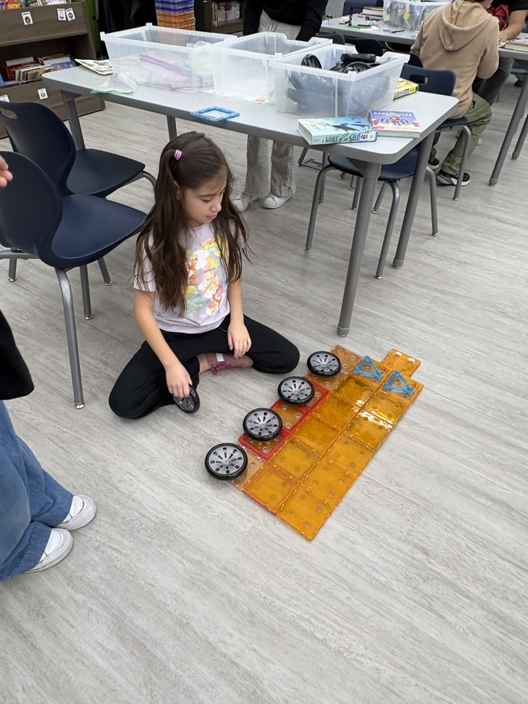 A student using stem building materials in a library. 