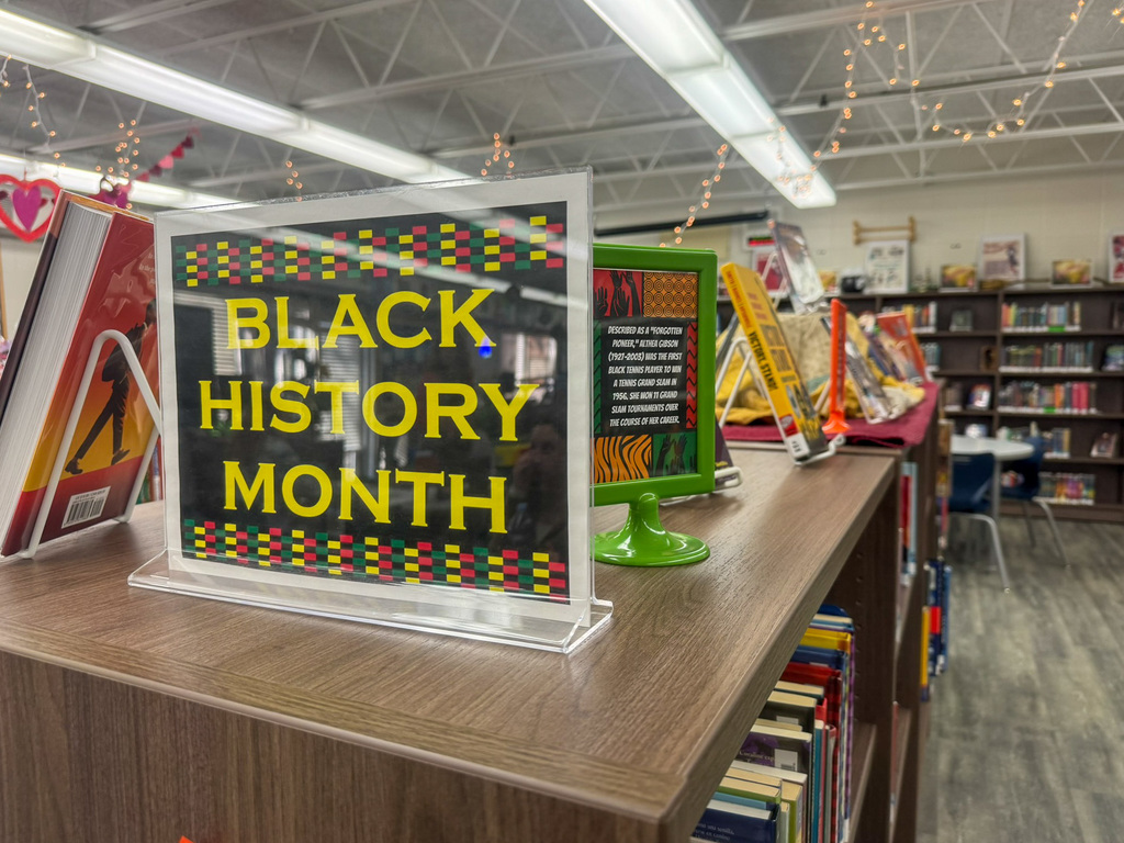 book shelf with placard on it Black History Month