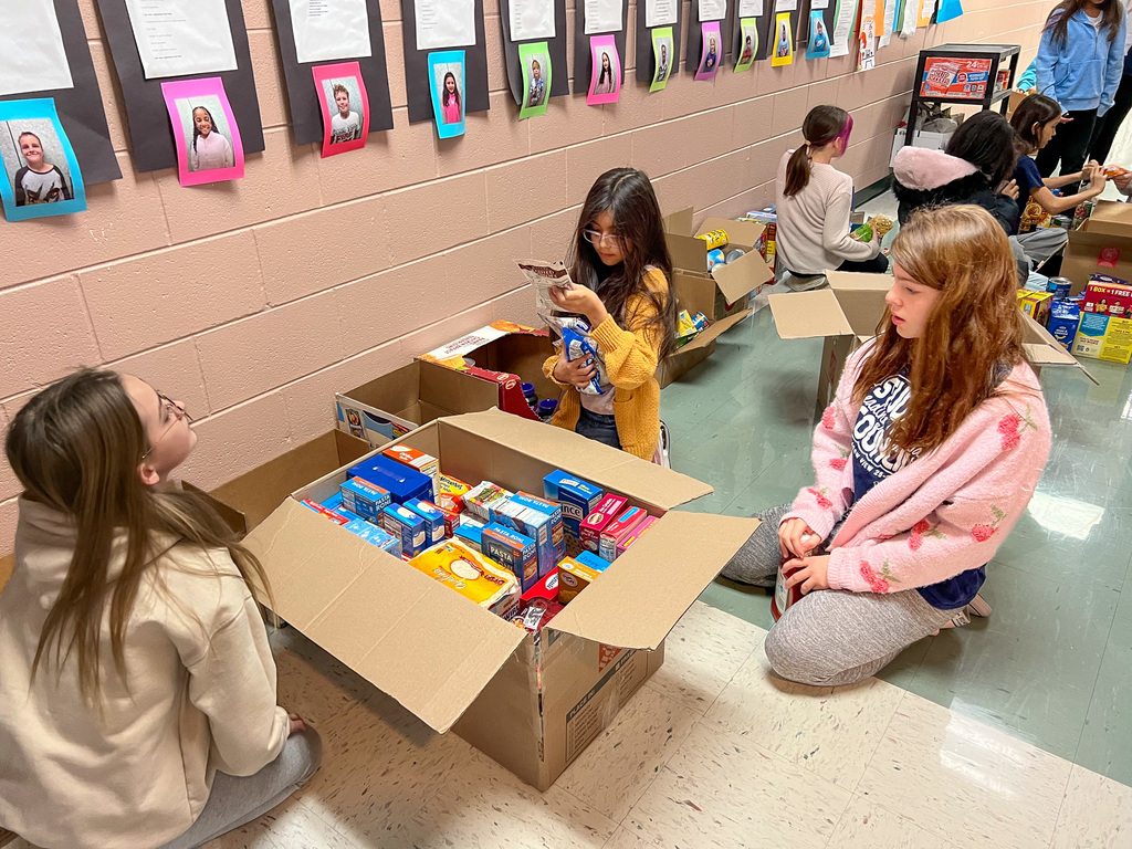 group of students organize food into boxes for Bags of Hope