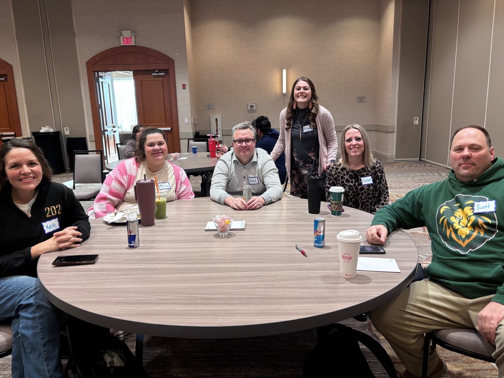 group of teachers sit at a table 