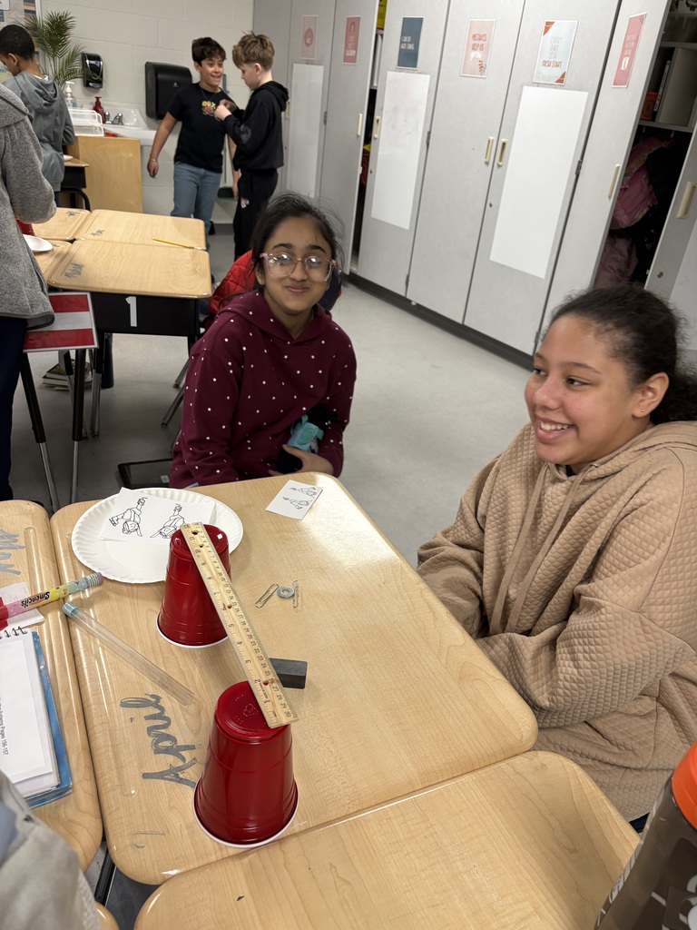 Students sitting at a desk. 