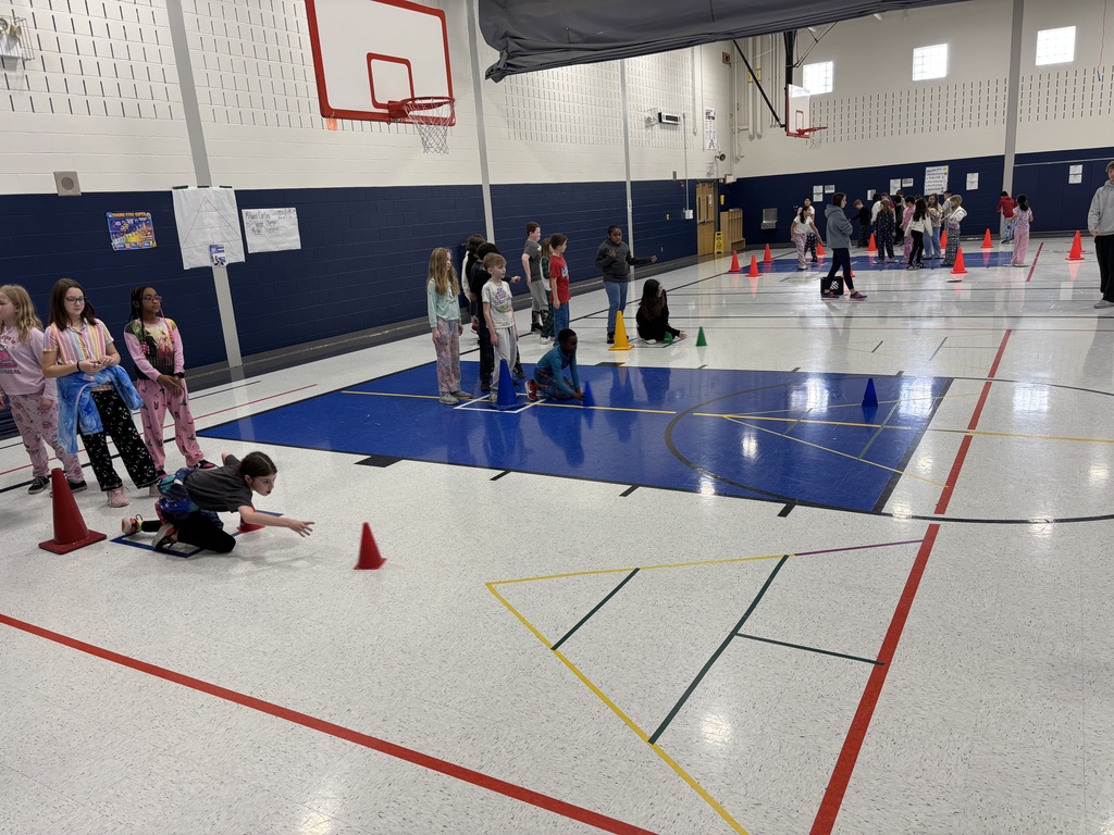 Students in a school gym playing an Olympic themed event.