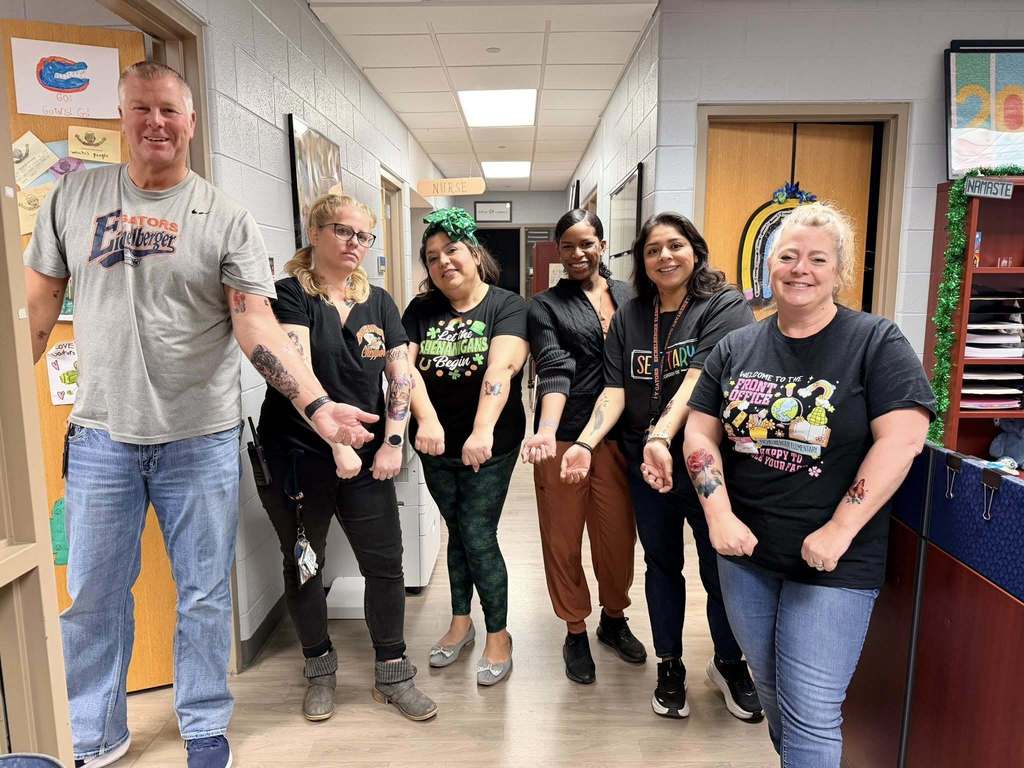 Eichelberger admin, teachers and staff show off their fake tattoos as part of a school fundraiser.