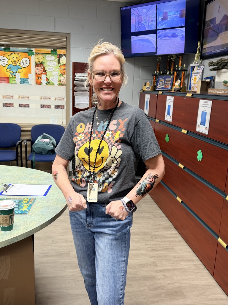 Eichelberger admin, teachers and staff show off their fake tattoos as part of a school fundraiser.
