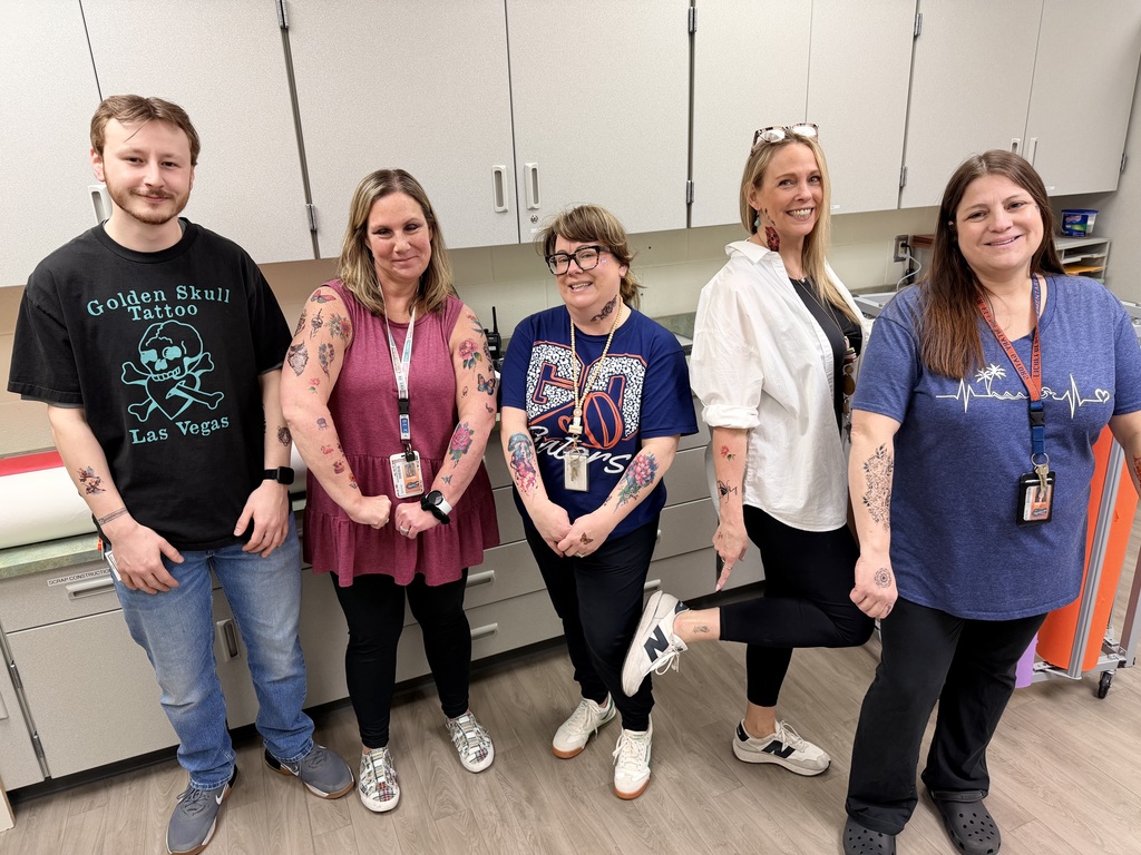 Eichelberger admin, teachers and staff show off their fake tattoos as part of a school fundraiser.