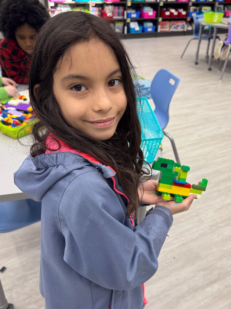 girl holding Lego animal in hands