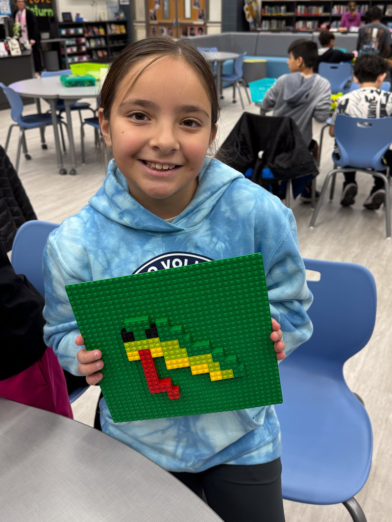 girl holding Lego snake on green background
