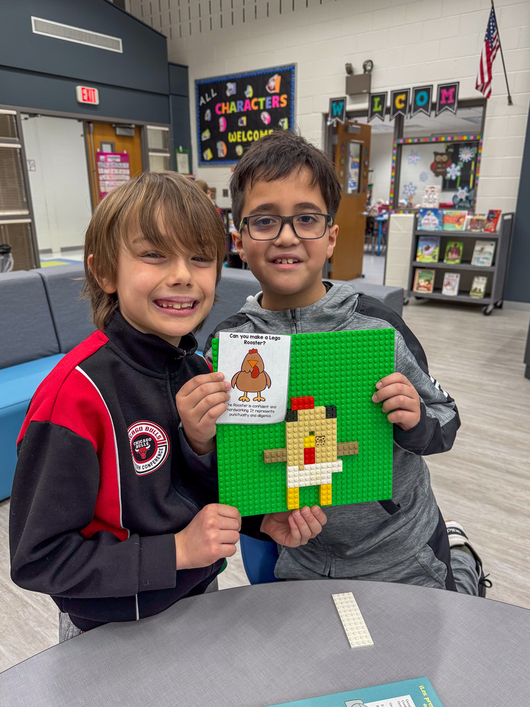 two boys hold Lego chicken on green background