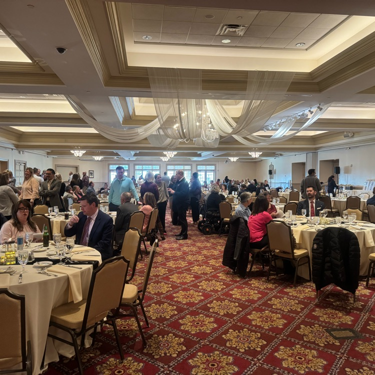 ballroom filled with people seated at banquet 