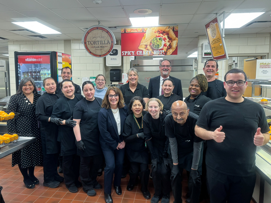Aramark kitchen workers pose with Illinois State Senator Meg Cappel in the Plainfield East High School cafeteria