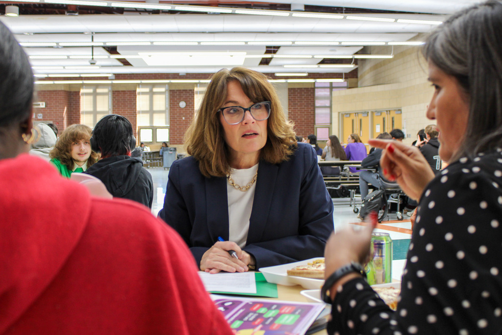 Illinois State Sen Meg Cappel listen to a woman to her right speak