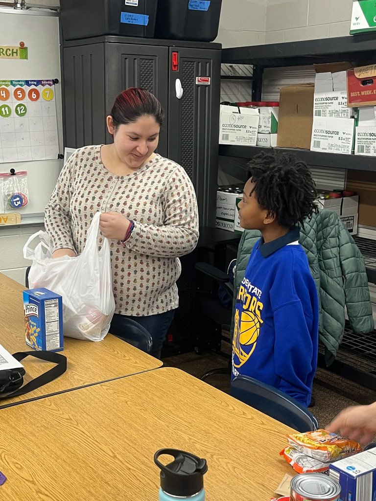 girl looking at boy while packing food into a bag