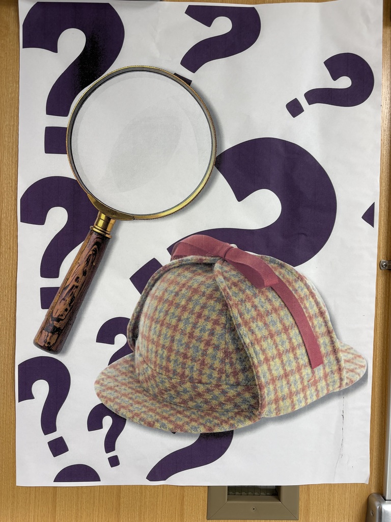 A magnifying glass and Sherlock Holmes hat poster. 