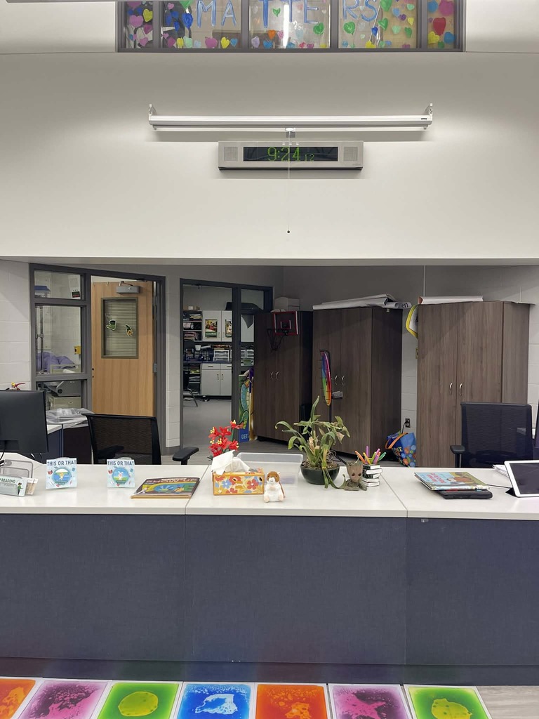 A small stuffed hamster on a library circulation desk