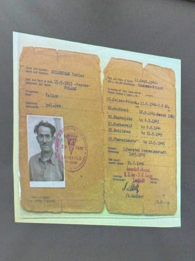 a yellowed identification document with a black and white photo on the left side