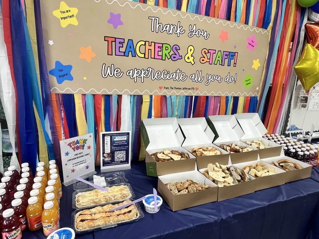 A table with juice and bagels.
