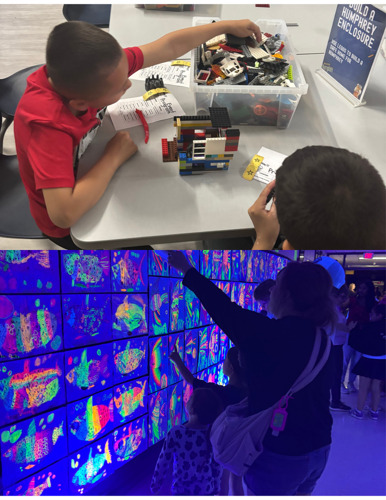 Two students standing in front of glow in the dark art and a student building with Legos