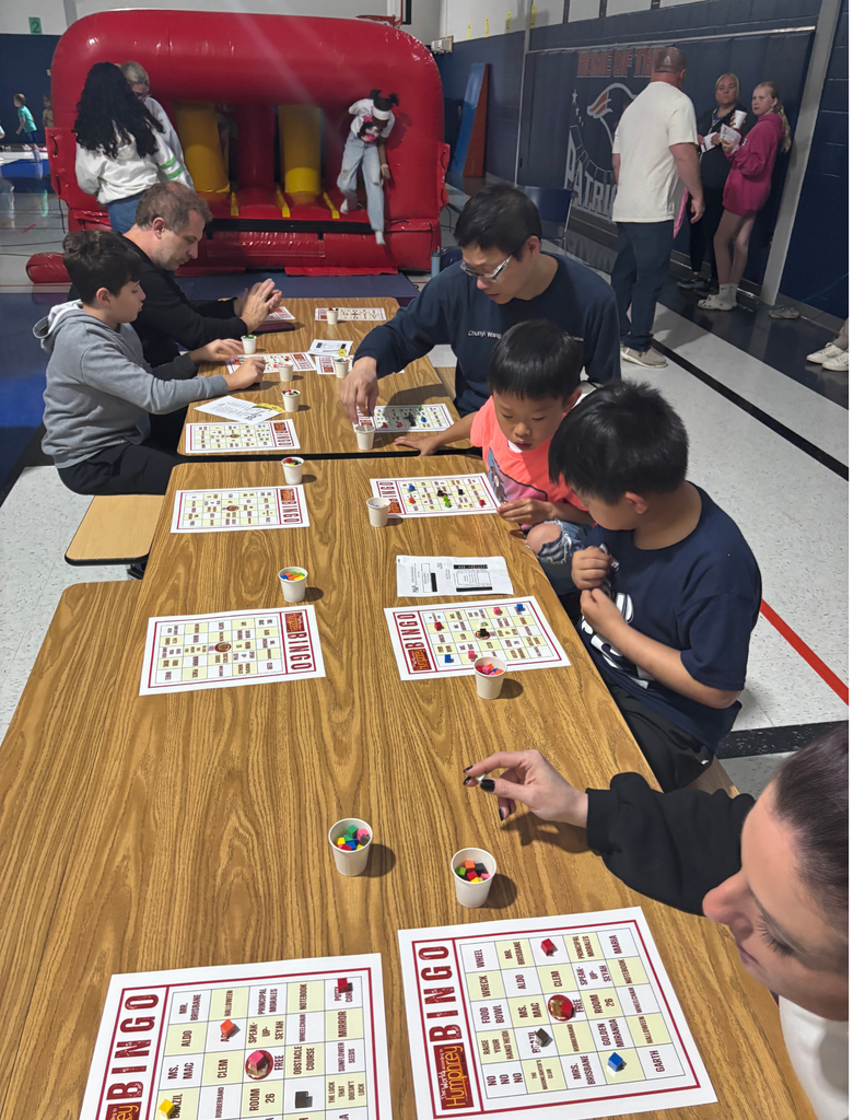 Families playing bingo in a school cafeteria.